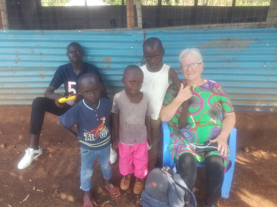 Sylvia Suhr with group of village children in Kenya